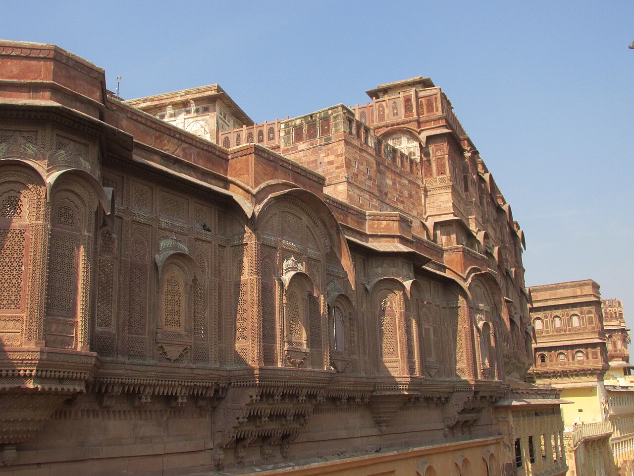 Ornate sandstone arches and facade at Mehrangarh Fort